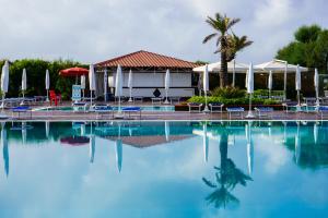 a large swimming pool with chairs and umbrellas at Puntaquattroventi in Ercolano