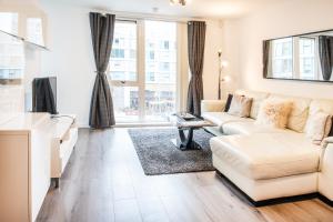 a living room with a couch and a table at City Stay Apartments - Hub in Milton Keynes