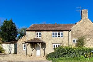 a large brick house with an awning in front of it at The Explorers Rest - Cottage - Frome in Buckland Dinham