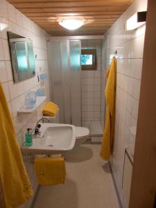 a white bathroom with a sink and a shower at Haus am Reh in Gargellen