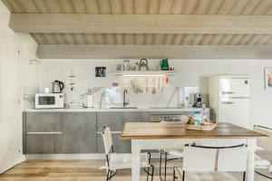 a kitchen with a wooden table and chairs in a room at Sound of Silence, Terre Marine in Corniglia