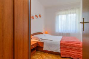 una camera con letto e specchio di Apartments Dubravka a Trogir