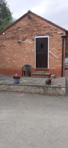 a brick building with a window and a bench at Church Farm in Stratford-upon-Avon