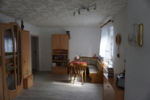 a kitchen with a table and a dining room at Am Sachsenstein - Zum Skispringer in Lauter