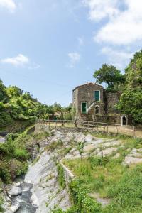 an old stone house on a hill next to a river at Villa Smith in Vernazza