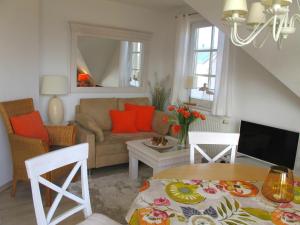 a living room with a couch and a table at Wiesenstraße 55 Whg 2 - Strandbuhne in Zingst