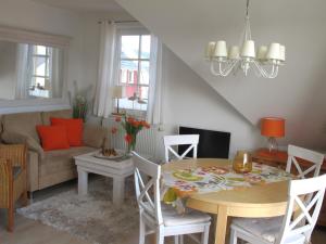 a living room with a table and a couch at Wiesenstraße 55 Whg 2 - Strandbuhne in Zingst