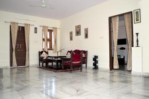 a living room with a table and chairs at Hotelier Hosts - A Home Stay in Jodhpur