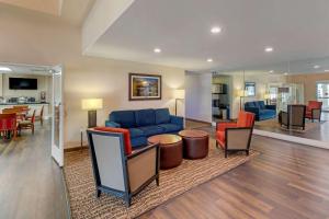 a living room with a blue couch and chairs at Comfort Suites Victorville-Hesperia in Victorville
