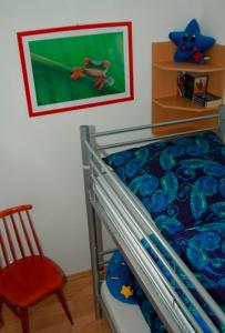ハイリゲンハーフェンにあるFerienwohnung mit Strandkorbのベッドルーム1室(二段ベッド1組、赤い椅子付)