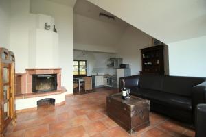 a living room with a black couch and a fireplace at Ostseekieker in Wustrow