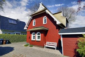 a small red house with a white roof at Carolin in Zingst