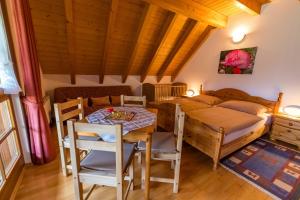 a room with a table and a bed and a bedroom at Schwarzwaldliebe in Fröhnd