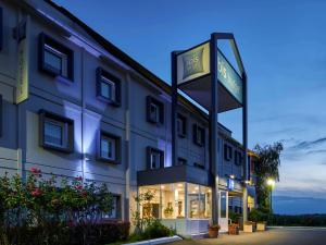 a hotel with a sign in front of a building at ibis budget Santeny in Santeny