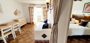 a bedroom with a bed and a desk and a table at Granada Apartments Familiar Deluxe in Portinatx