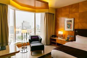 A bed or beds in a room at Lagos Continental Hotel