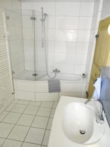 a bathroom with a shower and a sink and a tub at Am Backhaus in Gleiberg