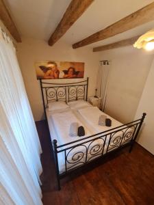 a bed in a bedroom with a painting on the wall at Seabed Apartma 1 in Piran