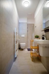 a bathroom with a sink and a toilet at Studio 13 "Rapsfeld" in Grömitz