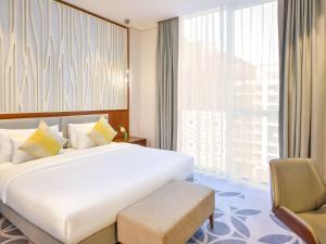 
A bed or beds in a room at Grand Mercure Hotel and Residences Dubai Airport

