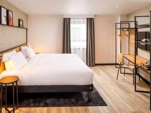 A bed or beds in a room at ibis London Sutton Point