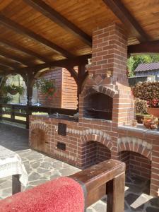 an outdoor brick pizza oven in a patio at CASA IKA&MATEI in Borşa