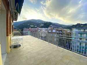 a balcony with chairs and a view of a city at residence cristallo in Alassio