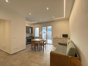 a kitchen and living room with a couch and a table at residence cristallo in Alassio +26 photos