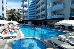 a swimming pool with people in a hotel at Kleopatra Ramira Hotel - All Inclusive in Alanya