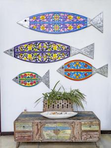 a wall with paintings of fish on it at Parangi Weligama Bay - Thema Collection in Weligama