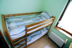 a wooden bunk bed in a room at Ferienwohnung, Steinwarder 9 in Heiligenhafen