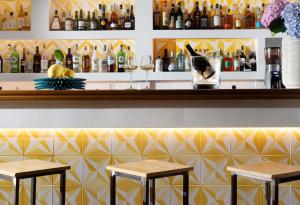 a bar with two stools in front of a counter at Boutique Hotel Casa Mariantonia in Anacapri