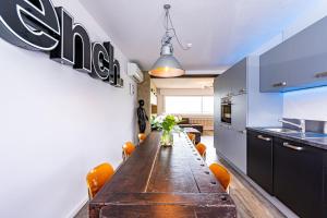 a dining room with a long table in a kitchen at Architektenwohnungen mit Panoramablick bei Köln in Lindlar