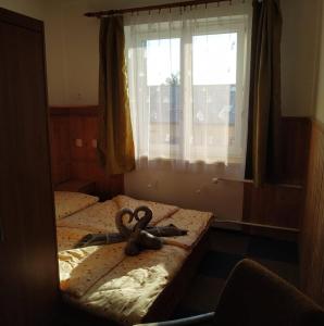 un par de tijeras en una cama en una habitación en Penzion Vysočina, en Škrdlovice