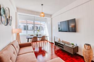 a living room with a couch and a tv at The Millennial Lifestyle Apartment in Funchal