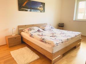 a bedroom with a bed with a wooden frame at Lake Side Vienna II in Vienna