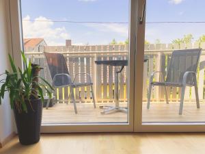 a sliding glass door with a table and chairs on a deck at Lake Side Vienna II in Vienna