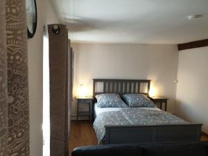 a bedroom with a bed with blue pillows on it at Torhaus Rattelsdorf - Wohnung Edelweiß in Rattelsdorf