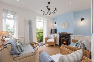 a living room with a couch and a fireplace at Robin Hood's Bay Coastguard's Cottage with a View in Robin Hood's Bay