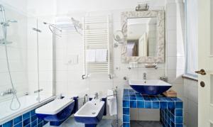a bathroom with a blue sink and a mirror at Boutique Hotel Casa Mariantonia in Anacapri