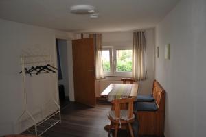 a room with a table and chairs and a window at Haus Engelskrug in Senheim