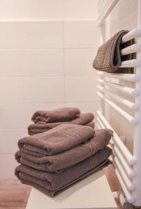 a stack of towels on a rack in a room at Huxfeld-Hof - Hamme in Grasberg