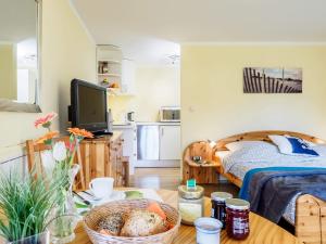 a living room with a bed and a table with a bowl of food at Seenest Appartement 2 in Zingst