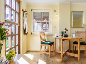 a dining room with a table and a window at Seenest Appartement 2 in Zingst