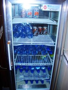 a refrigerator filled with lots of drinks and soda at Li’s Chain Hostel in Hong Kong