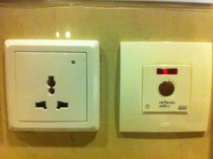 a couple of light switches on a wall at Li’s Chain Hostel in Hong Kong