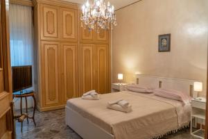 a bedroom with a bed with two towels on it at Via Sparano Suite in Bari