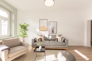 a living room with a couch and a table at limehome Dresden Jordanstraße in Dresden