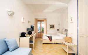 a bedroom with a bed and a desk in a room at Boutique Hotel Casa Mariantonia in Anacapri