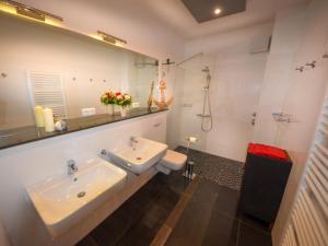 a bathroom with a sink and a mirror at Ferienwohnungen Marienthal in Hamburg +63 photos